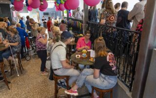 "Cliënten en medewerkers genieten van een lunch in een sfeervolle foyer tijdens de tweede dag van het 40-jarig Coppes Festival."